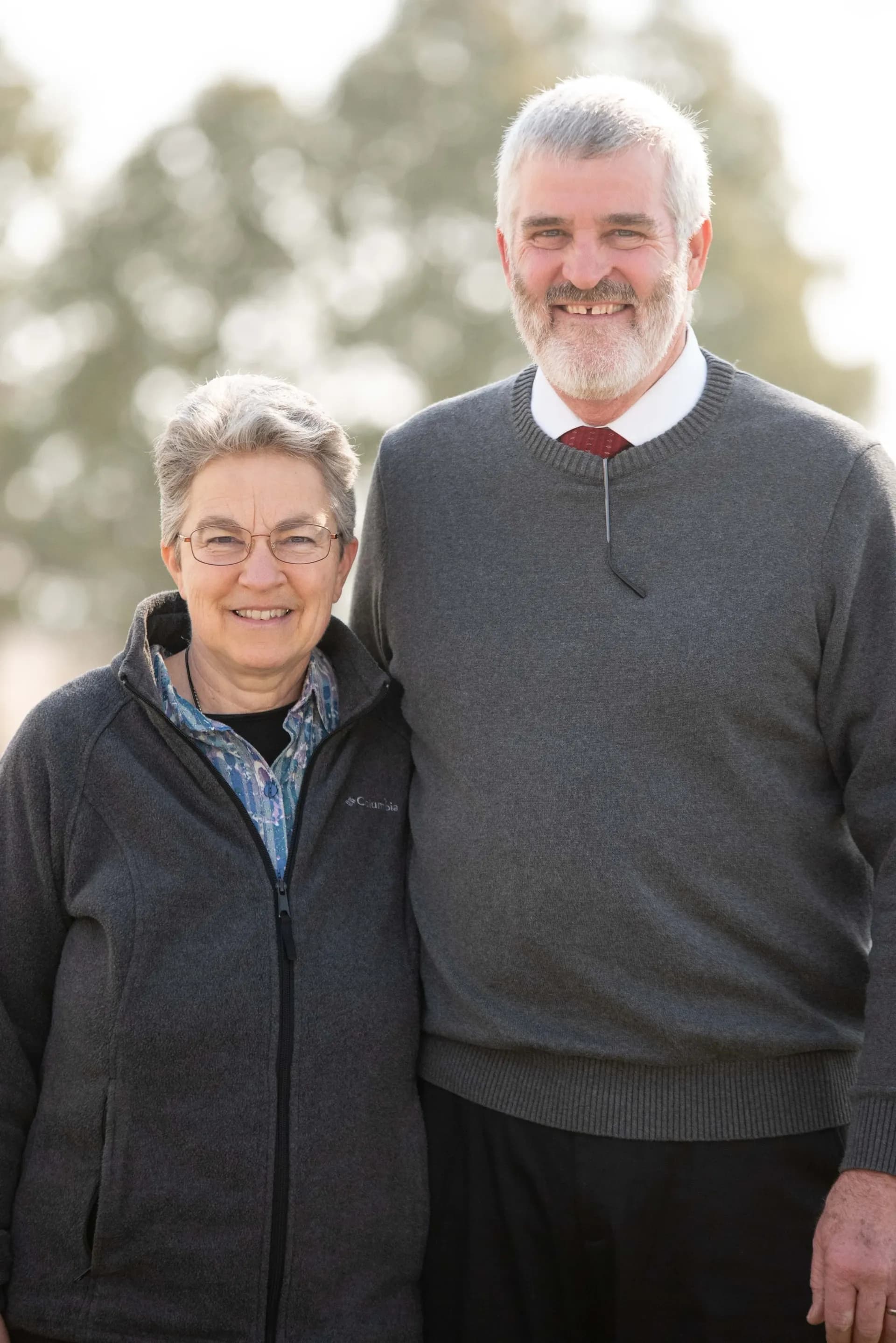 Picture of a middle aged couple smiling outside in the yard of Sharon RP Church